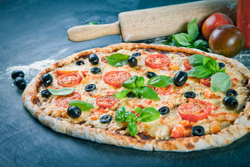 Home made raw pizza with prosciutto and blue cheese. The dough w