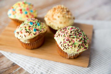 close up of glazed cupcakes or muffins on table