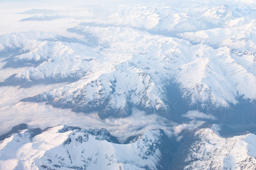 Above the clouds aerial view of snowcapped andes mountains