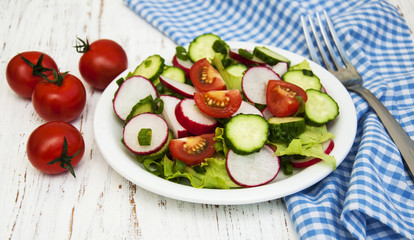 Spring salad with tomato, cucumbers and radish