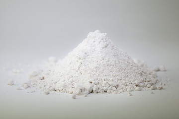 Wheat flour heap on white background