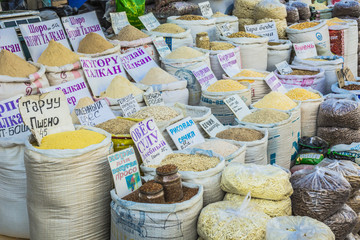 Vivid oriental central asian market with bags full of various sp