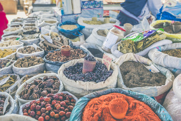Vivid oriental central asian market with bags full of various sp