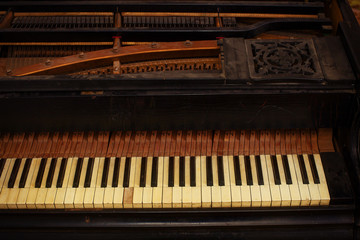 Fototapeta na wymiar piano keys and wood grain with vintage sepia tone one ragged key