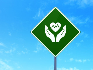 Insurance concept: Heart And Palm on road sign background