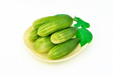 Several fresh cucumbers on a dish