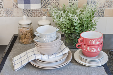 set of plates and dish on counter in kitchen room