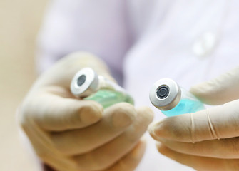 Two vials holding by a doctor