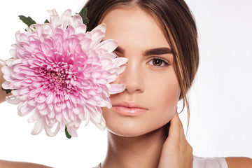 Pretty girl with chrysanthemum flower on half face