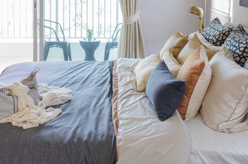 pillows on modern bed with grey blanket