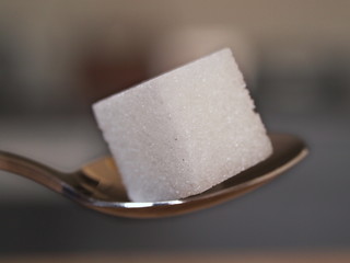 A lump of sugar on a teaspoon.