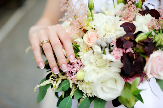 Bride's hands with a wedding ring on a finger
