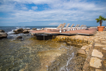 loungers on the rocky beach