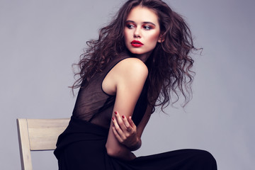 Closeup portrait of young beautyful woman with curly hair.