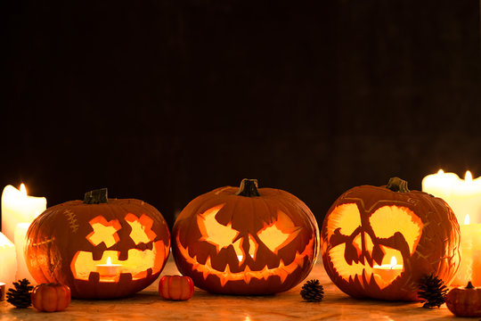 Three carved halloween pumpkin lanterns