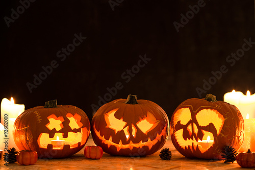 Three carved halloween pumpkin lanterns