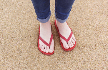 flip flops on a woman on the beach