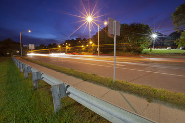 A long exposure night scene of motion blurred light streaks on a road
