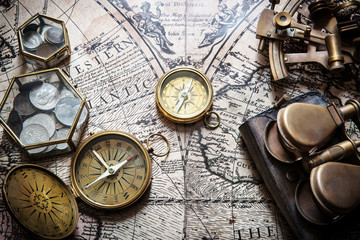 Fototapeta na wymiar Old compass, astrolabe on vintage map. Retro style.