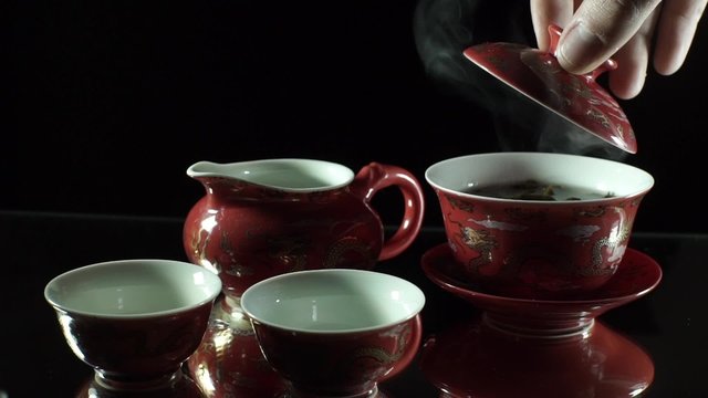 Hot tea on the black background - Chinese style.