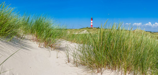 Dune landscape with lighthouse at North Sea