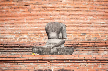 Damaged Buddha statue in the grounds of Wat Mahathat, Ayutthaya, Thailand