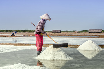 The woman working on salt fields, Vietnam.