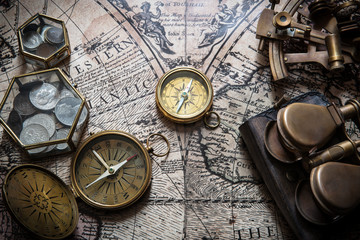 Fototapeta na wymiar Old compass, astrolabe on vintage map. Retro style.