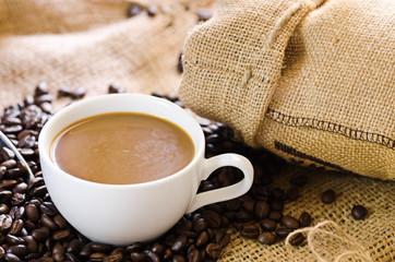 coffee cup with coffee beans around