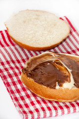 Bread with chocolate cream on the kitchen table cloth