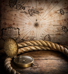 Fototapeta na wymiar old compass and rope on vintage map