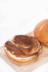 Donuts with chocolate cream on the wooden board