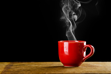 red coffee cup with smoke on black background