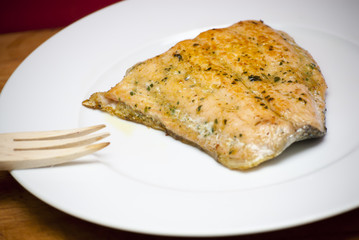 Grilled salmon on a white plate
