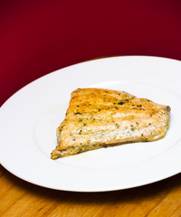 Grilled salmon on a white plate