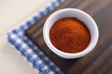 Paprika. High angle view of white bowl full of paprika. Very shallow depth of field.