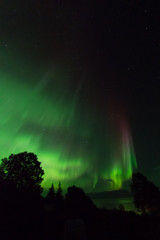 Red aurora streak over Kachemak bay Alaska