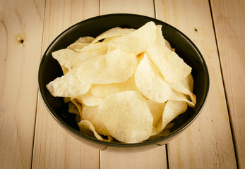potato chips on wood - soft focus with vintage film filter