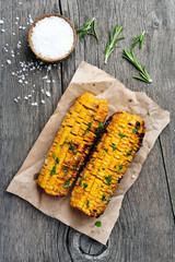 Grilled corn cobs on wooden background