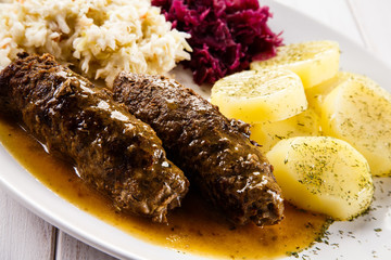 Wrapped stuffed beef, boiled potatoes and vegetables 