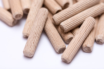 Pile of wooden dowels on the white background