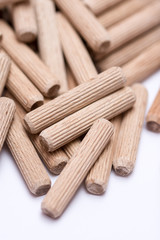 Pile of wooden dowels on the white background