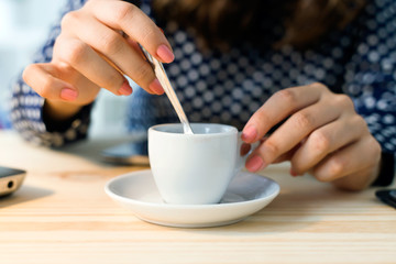 Beautiful young woman drinking coffee in her office.
