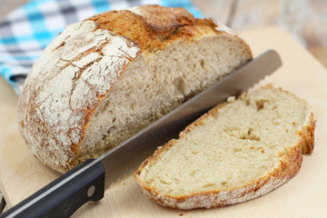 Rustic whole grain bread on wooden board
