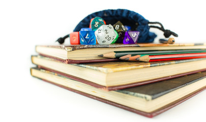 Dice and Pencils on top of Books