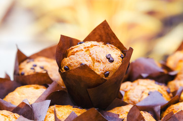 Bunch of muffins with selective focus and blurred warm background