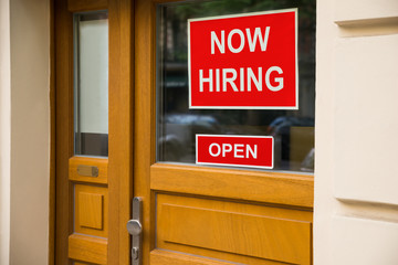 The Text Now Hiring Sticker Attached On Door