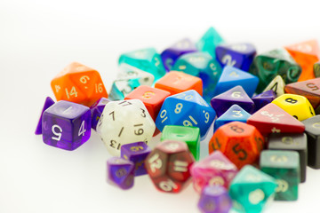 Pile of multicolored gaming dice on a white surface