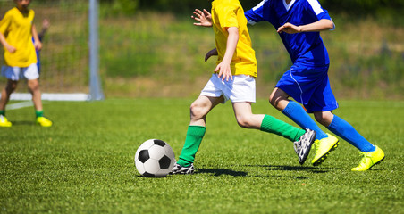 Fototapeta premium Football soccer game. Players footballers running and playing fo