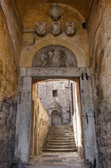 Old and aged gate to a courtyard at the Old Town in Dubrovnik, Croatia.
